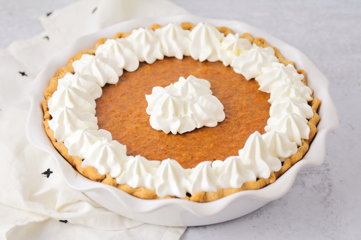 Sweet potato pie topped with whipped cream