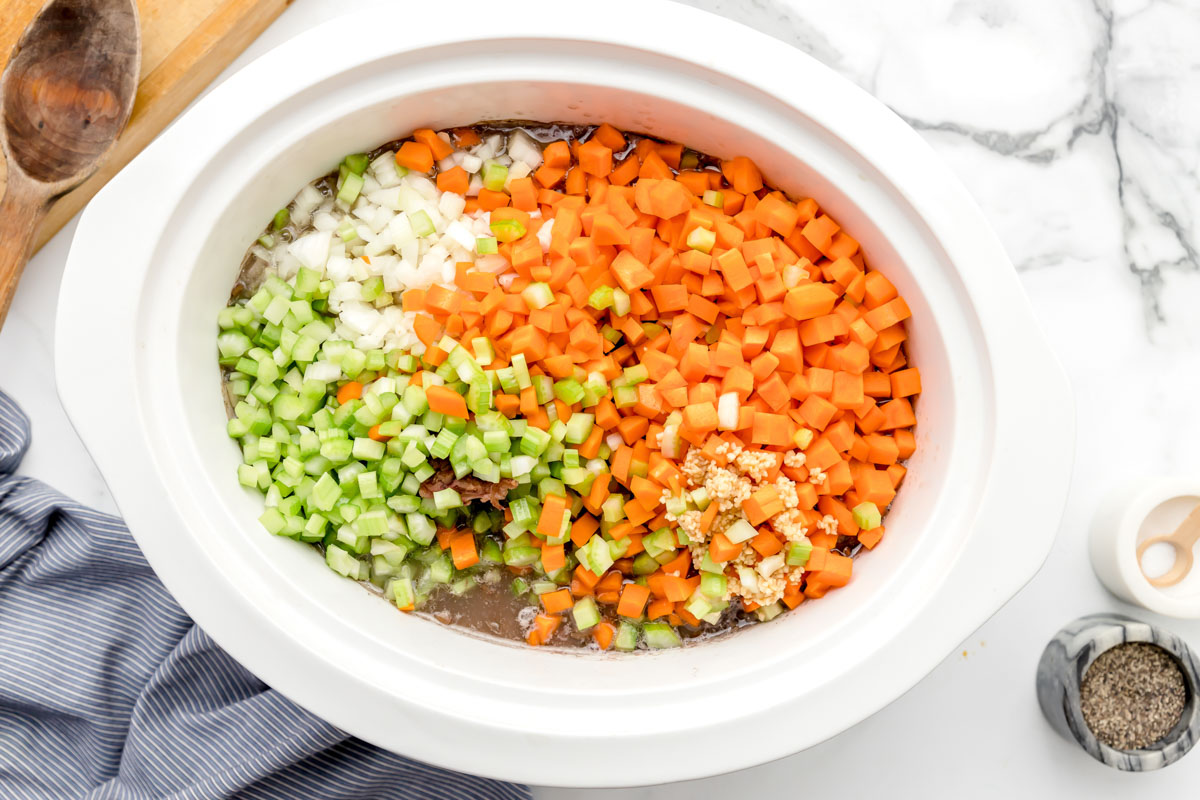 chopped veggies for ham and bean soup in a crock pot