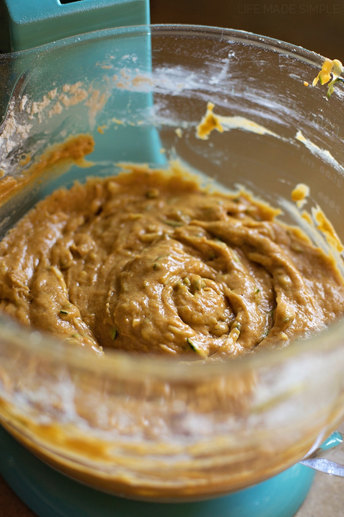 Pumpkin and spice adds a hint of fall to this moist and tender pumpkin zucchini bread. It's easy to make and even easier to customize! A mixing bowl filled with thick pumpkin zucchini bread batter.
