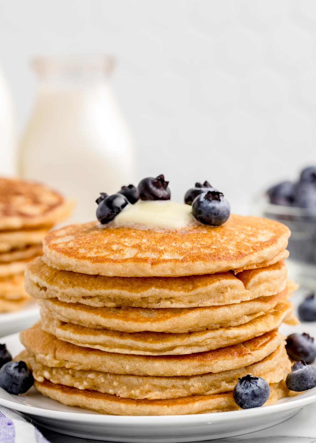 Stack of whole wheat blender pancakes topped with blueberries