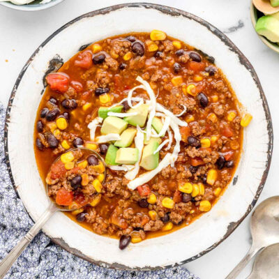 Instant Pot Taco Soup topped with cheese in a bowl.