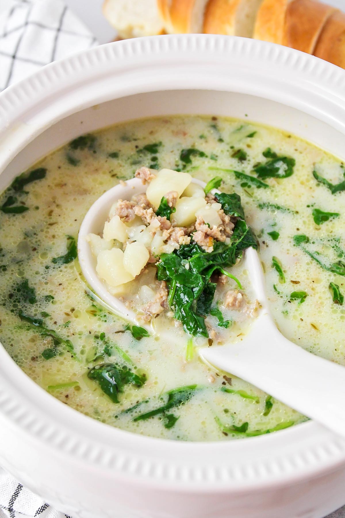 White bowl filled with instant pot zuppa toscana.