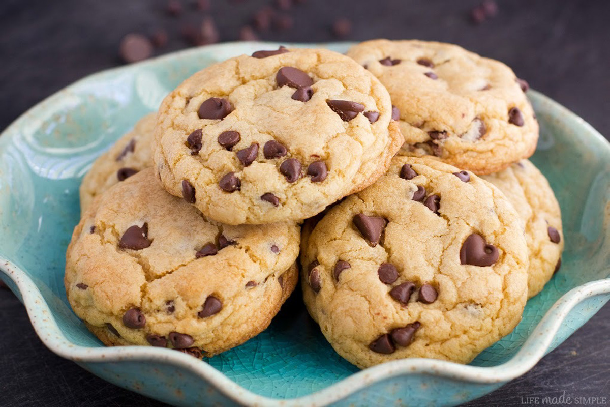 Soft-batch chocolate chip cookies stacked in a bowl.