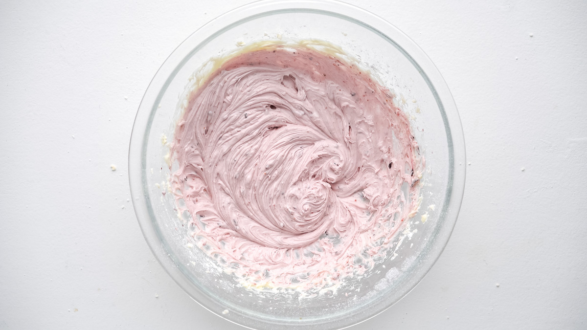 Blueberry cream cheese frosting in a glass bowl.