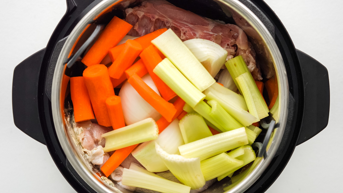 Instant Pot with turkey, broth and veggies in it