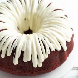 This Red Velvet Bundt Cake recipe is fluffy, filled with chocolate chips and topped with a smooth cream cheese frosting!