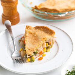 A slice of Vegetable Pot Pie on a white plate.