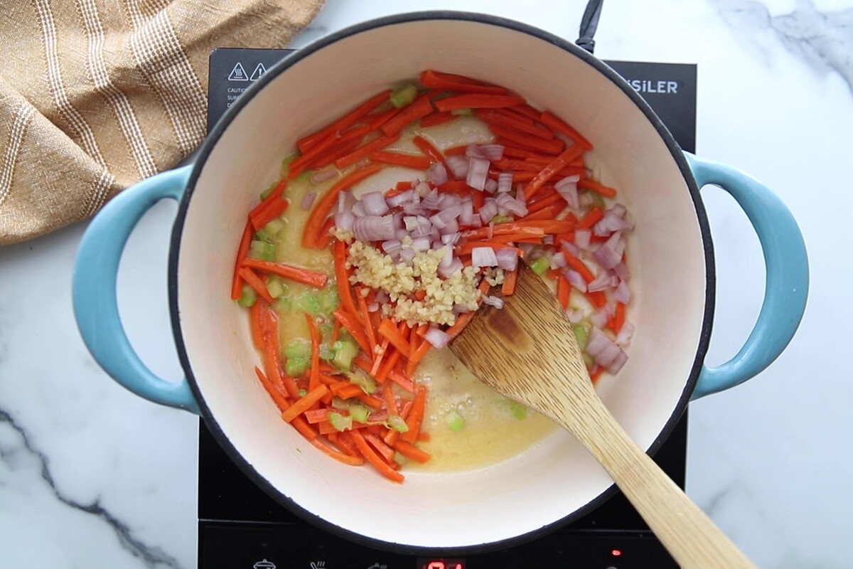 Celery, carrots, shallots, and garlic were added to the Dutch oven.
