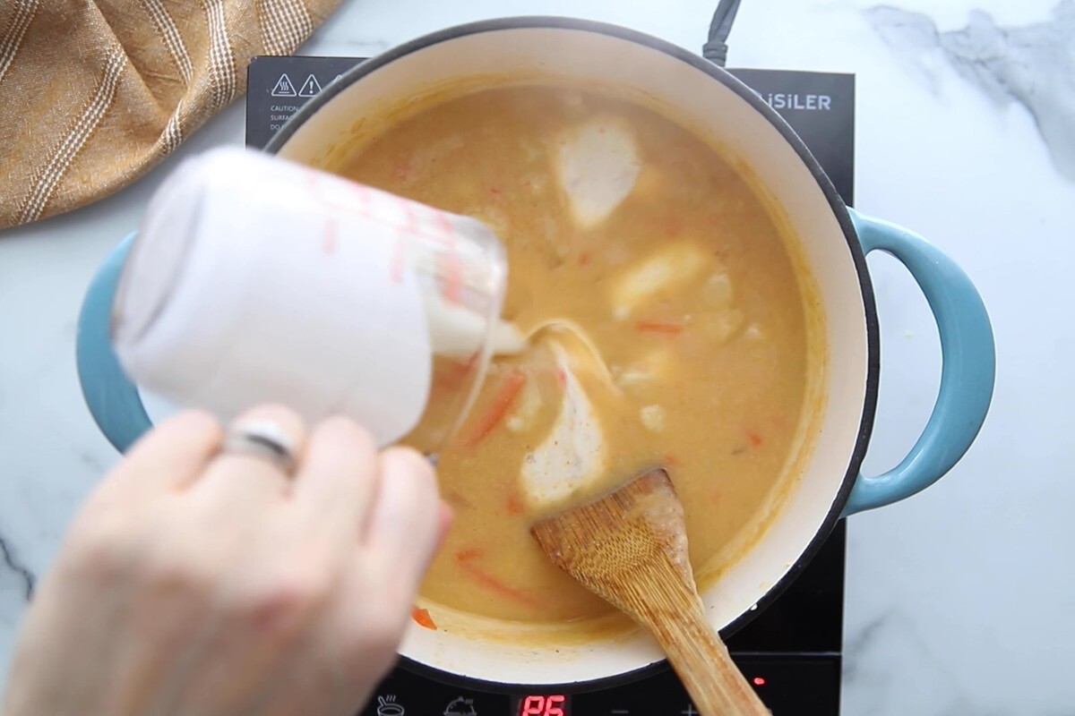 Pouring cream into the pot.