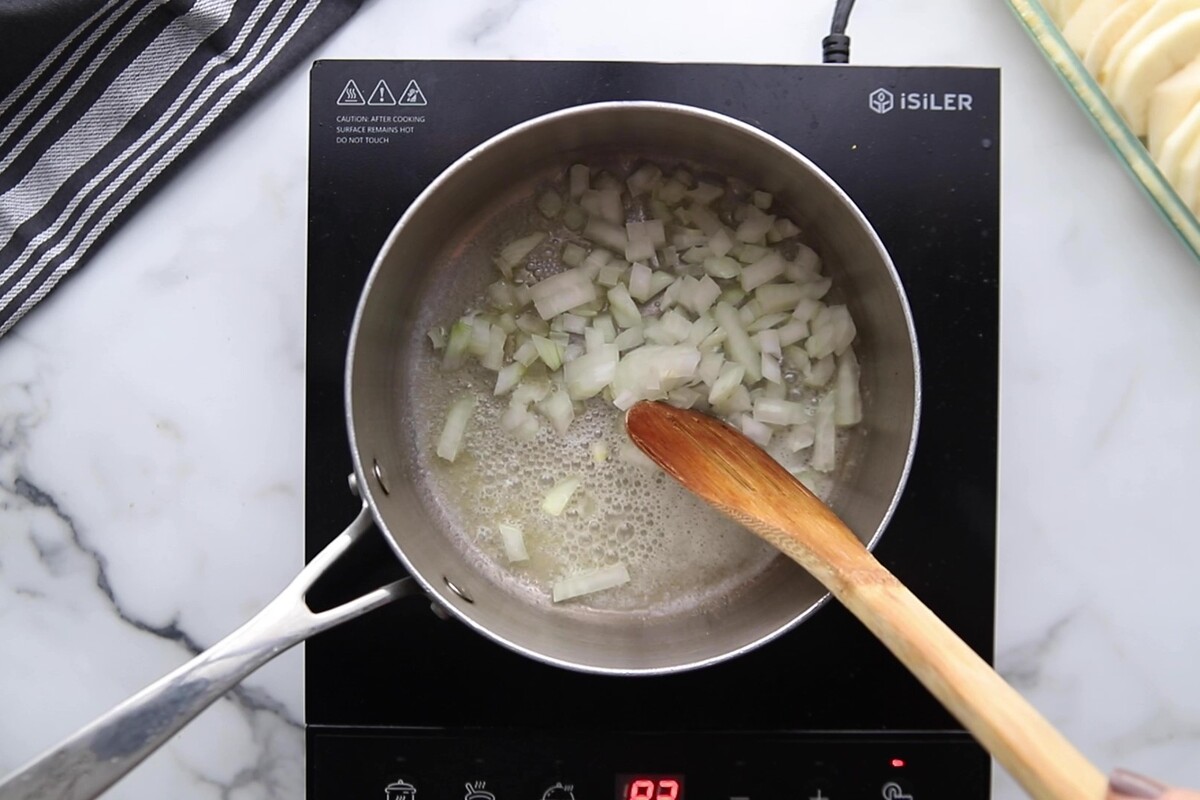 Saut&eacute;ing onion in a saucepan.