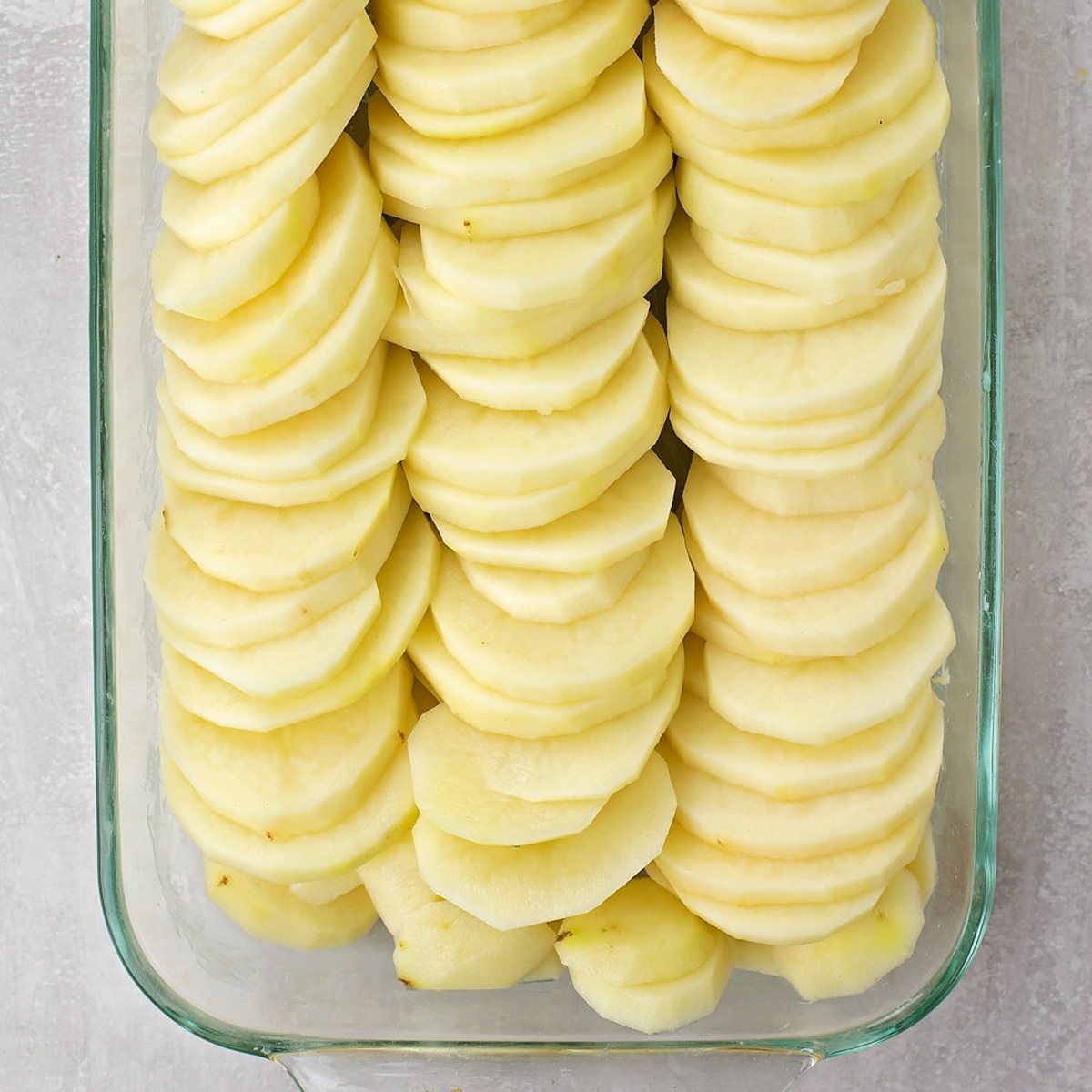 Lined potatoes in a pan.