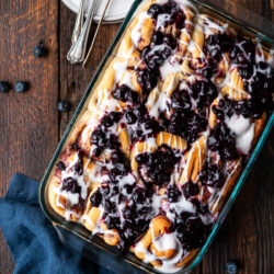 These Blueberry Cinnamon Rolls are sweet, tangy, and super fluffy. They are certain to be your family's new favorite breakfast treat!
