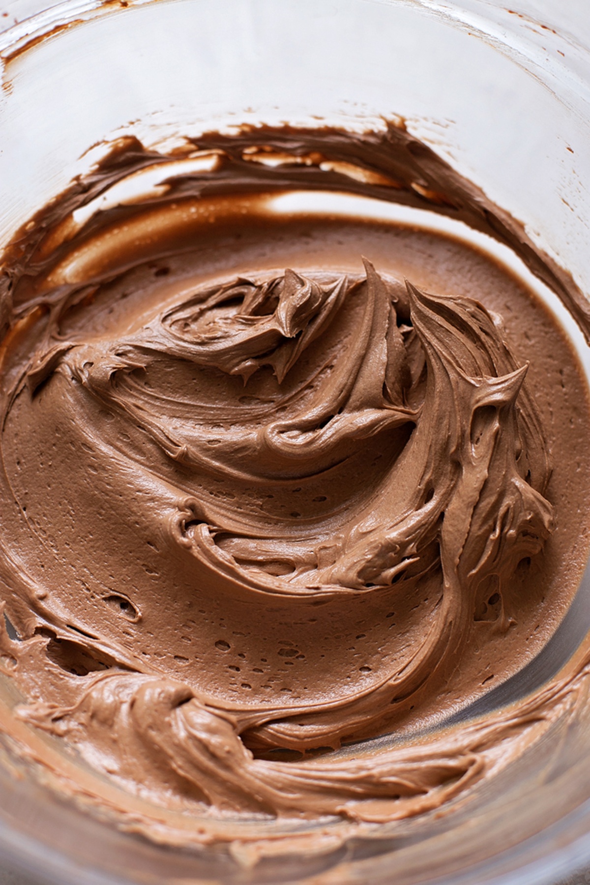 Chocolate frosting in a bowl for our Easy Chocolate Cake.