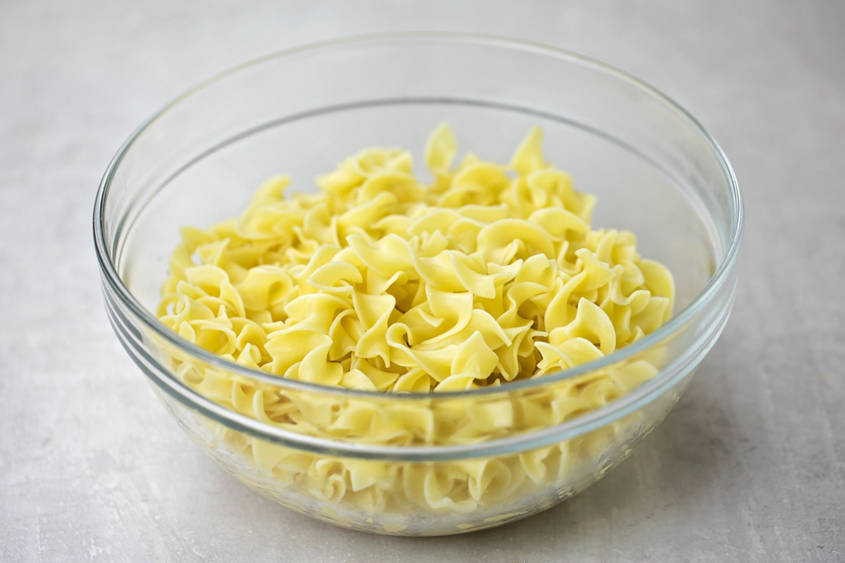 A glass bowl with pasta.