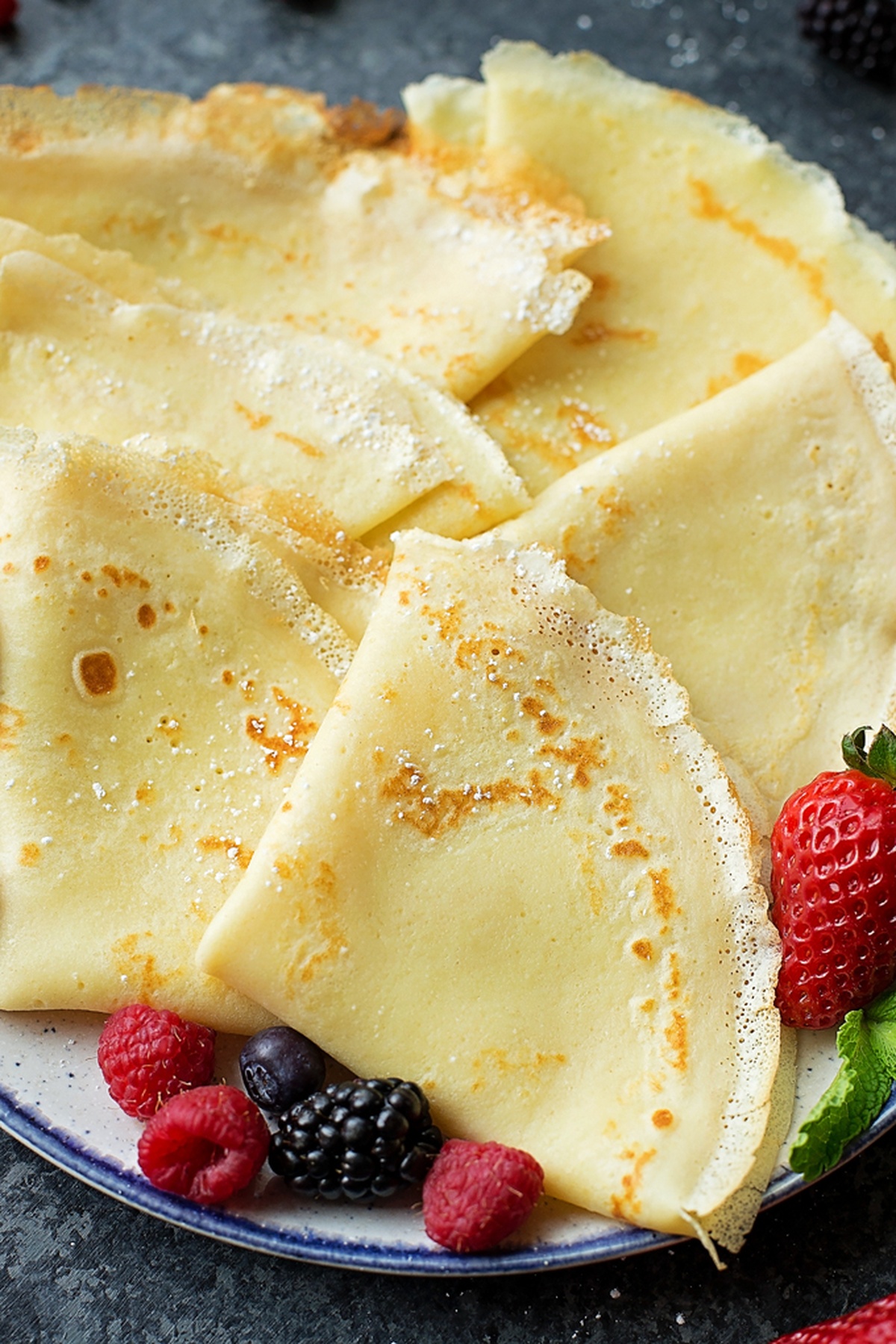 Plain crepes with fresh berries on the side.