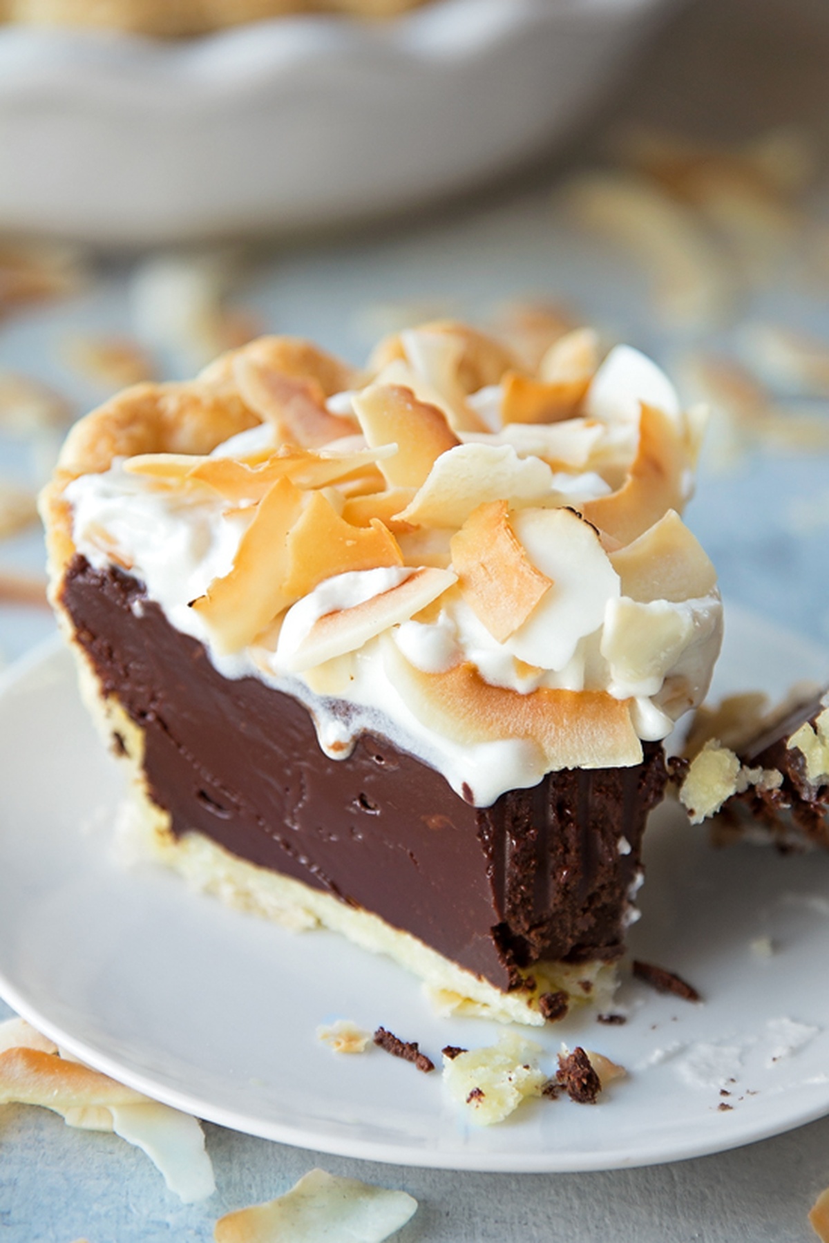 Close-up of a slice of chocolate coconut cream pie on a plate.