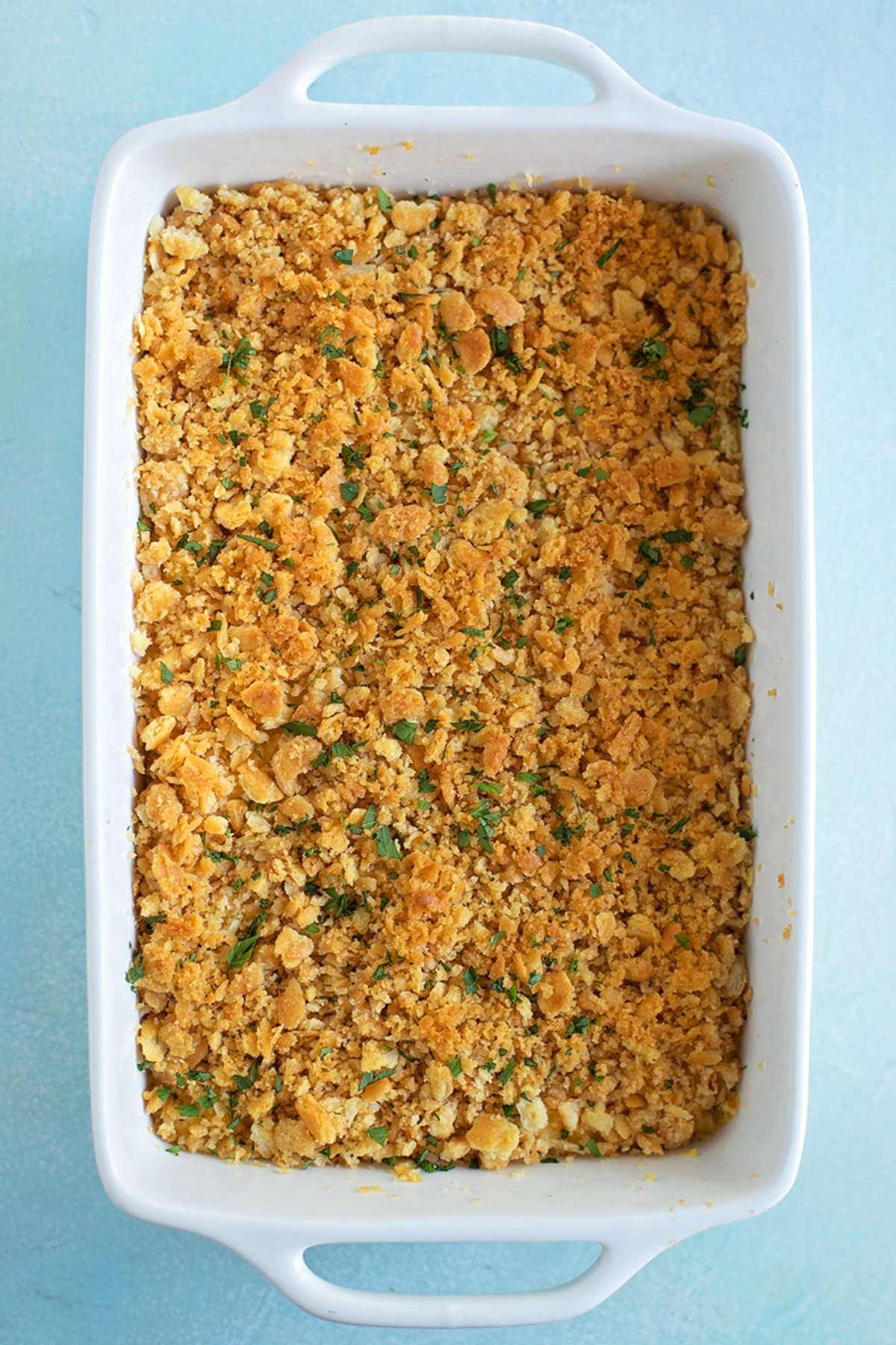 Casserole dish filled with unbaked corn casserole.