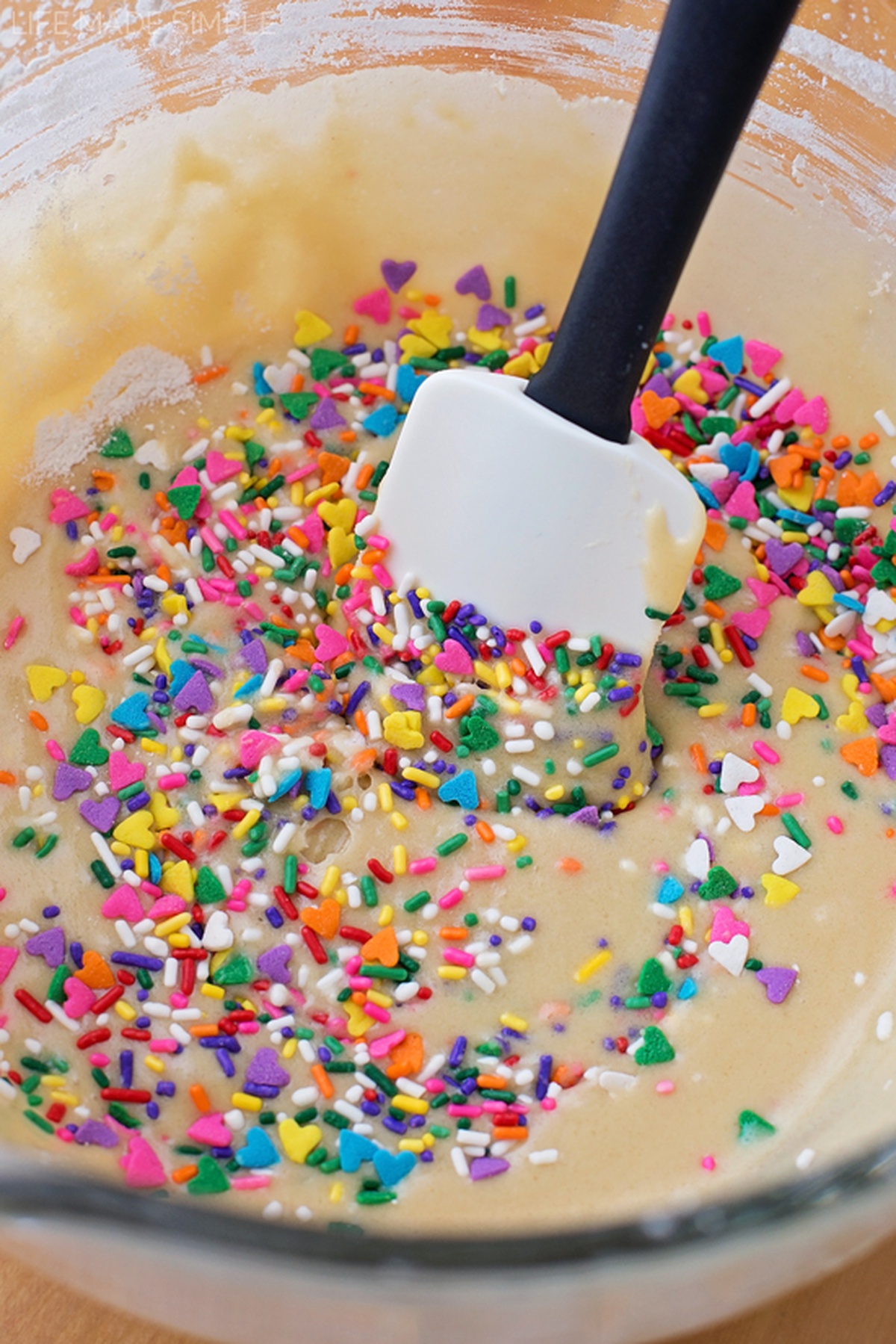 Mixing bowl with Funfetti blondie batter and sprinkles.