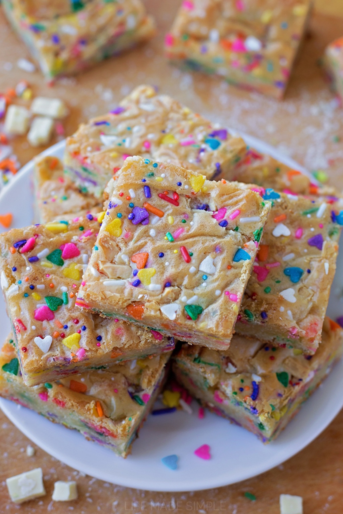 Plate full of Funfetti blondies topped with sprinkles.