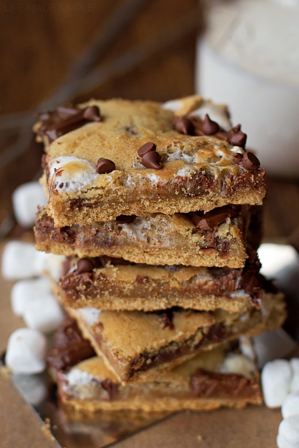 A tall stack of s'mores bars with visible layers of marshmallow and chocolate."