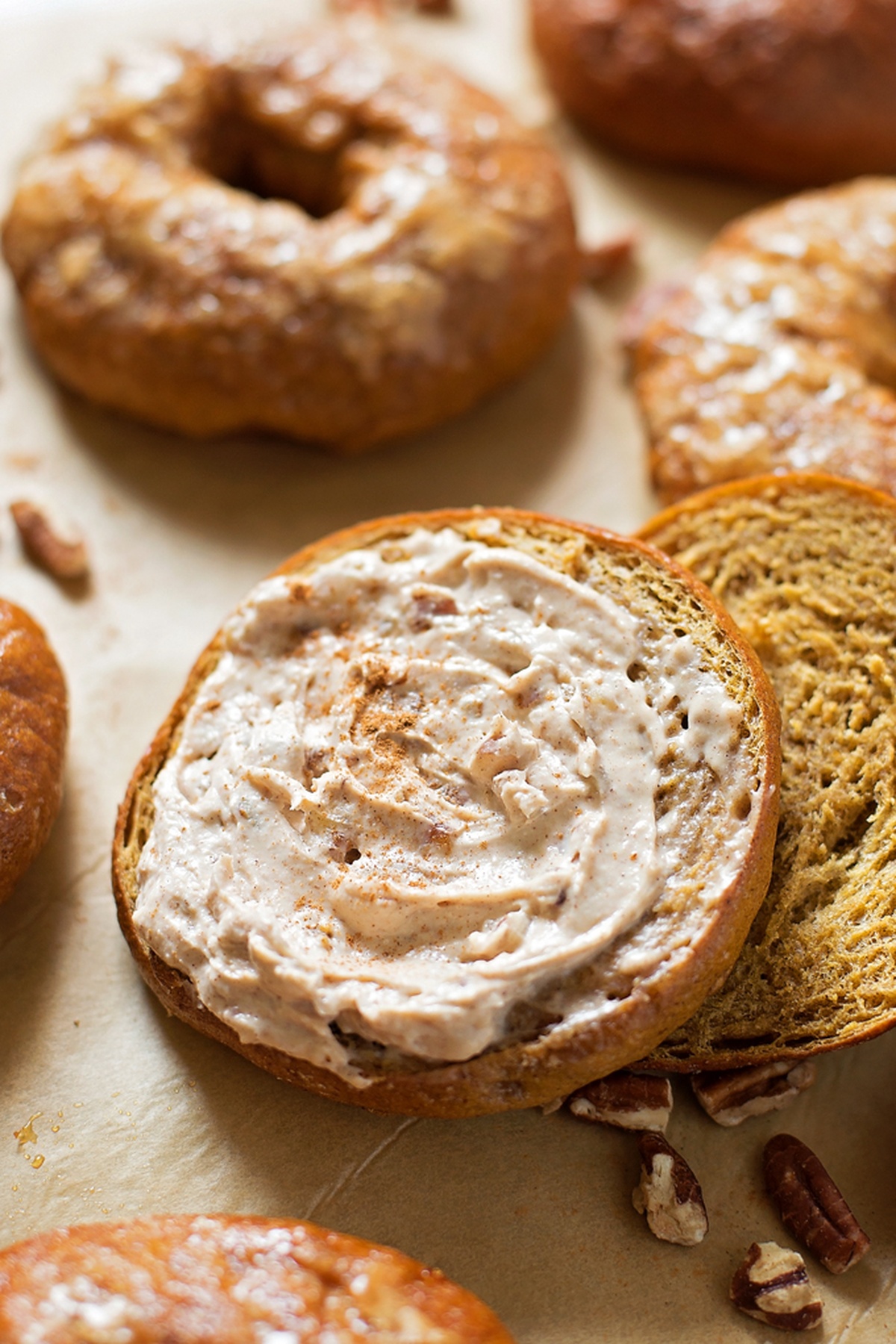 Homemade pumpkin bagel with cream cheese and pecans.