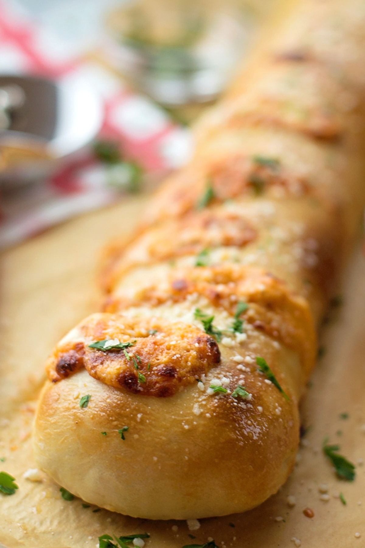 Freshly baked ricotta stromboli, golden brown and topped with herbs and parmesan.