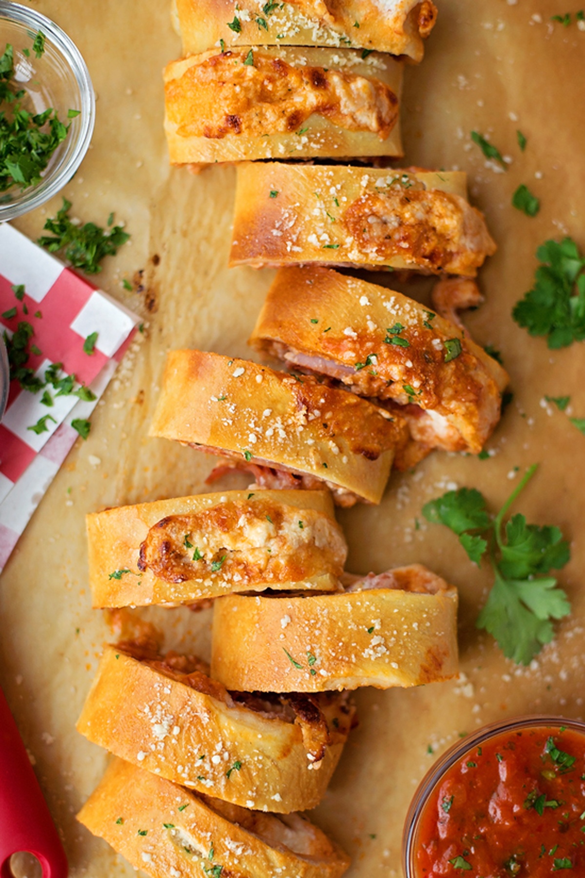 Sliced Homemade Pepperoni Stromboli on a parchment paper.