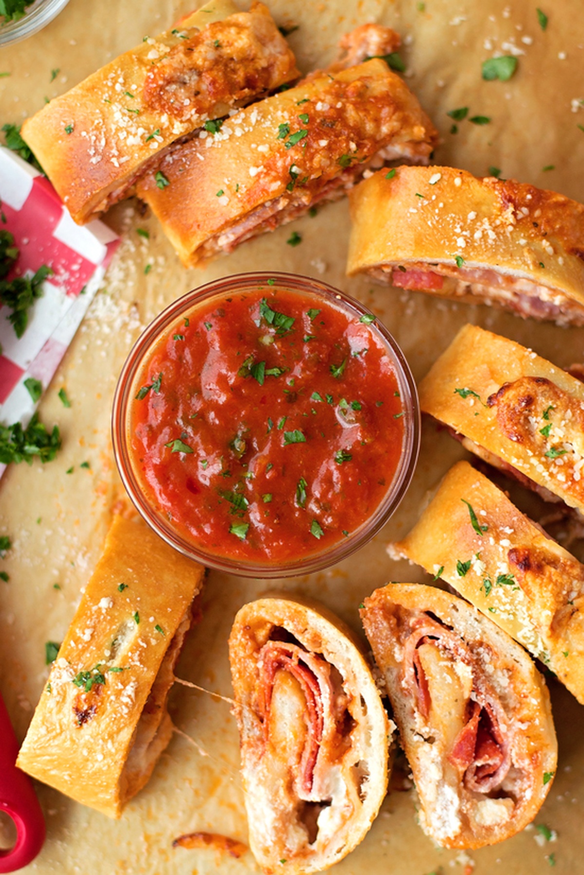 Sliced pepperoni stromboli with marinara sauce.