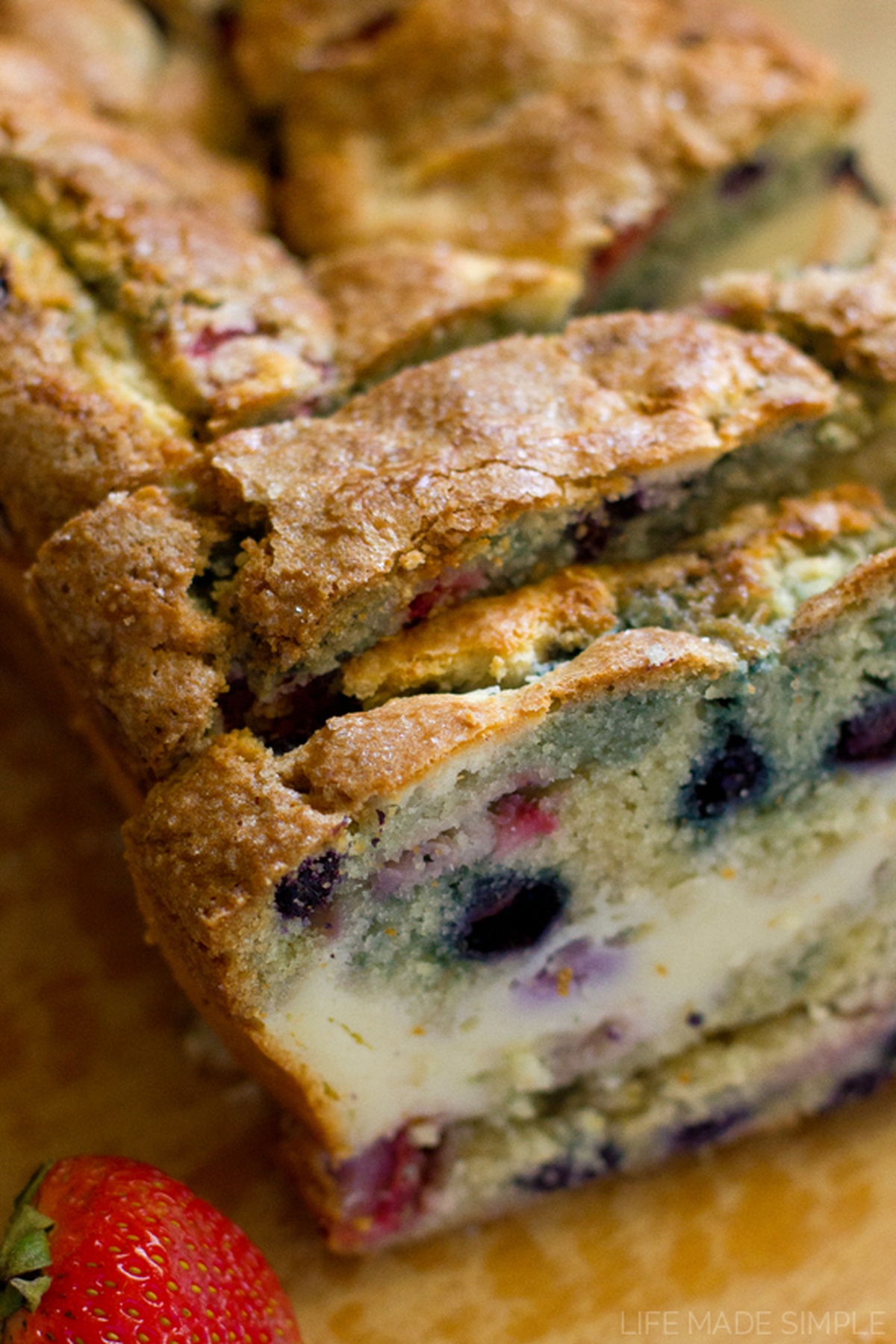 Close-up of sliced Red, White & Blueberry Bread showing fruit and cream cheese layers.