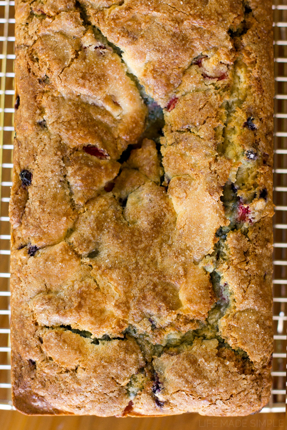 Top view of the entire loaf of Red, White and Blueberry Bread on a cooling rack.