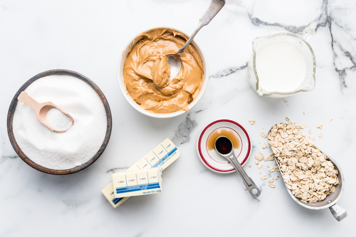 Ingredients for No Bake Peanut Butter Oatmeal Cookies on a marble surface.
