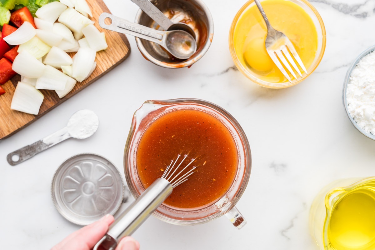 Whisking the sweet and sour sauce.