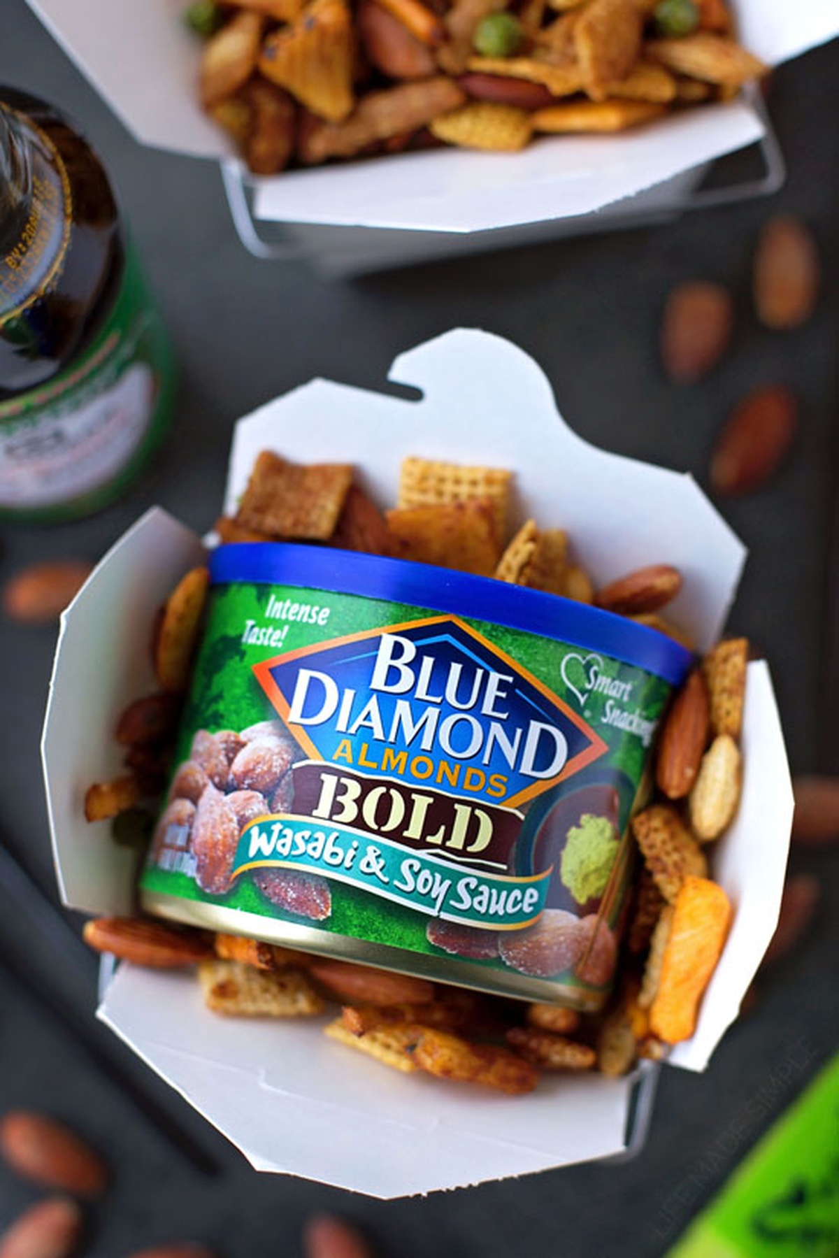 A takeout box filled with Asian snack mix.