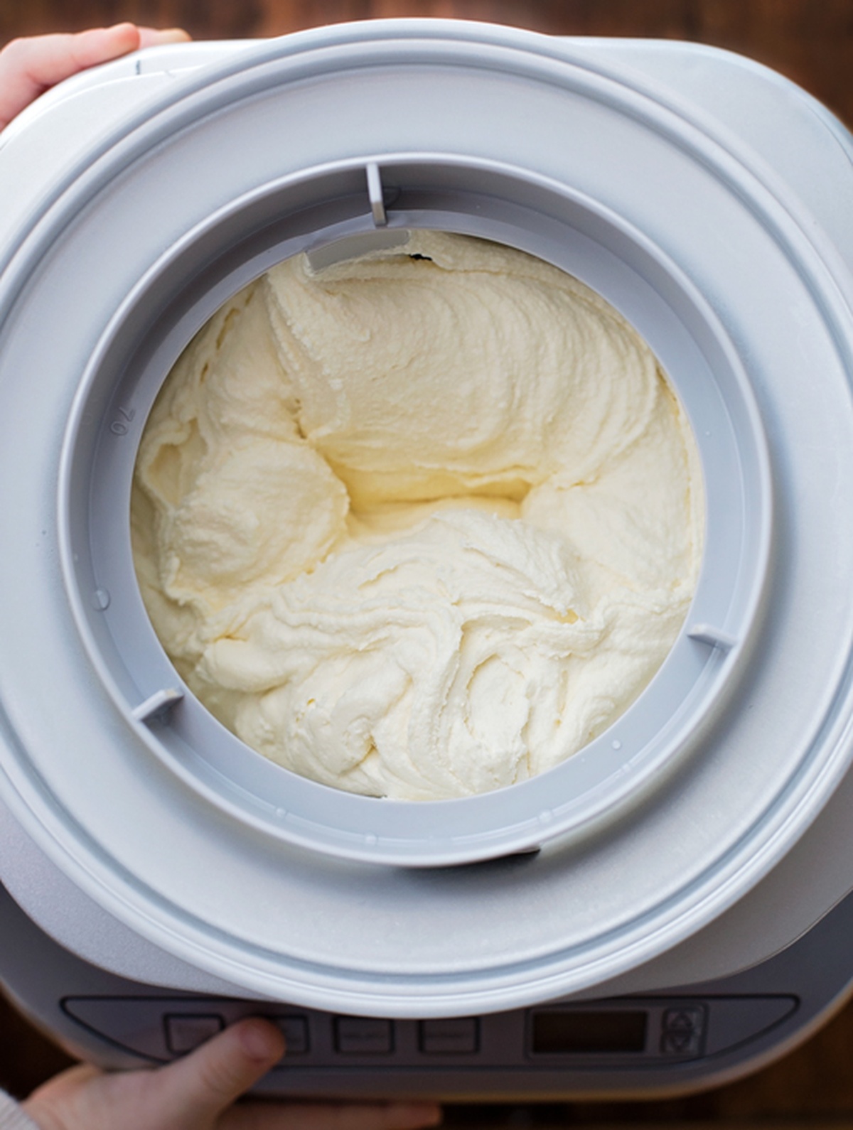 Freshly churned vanilla ice cream inside an ice cream maker.