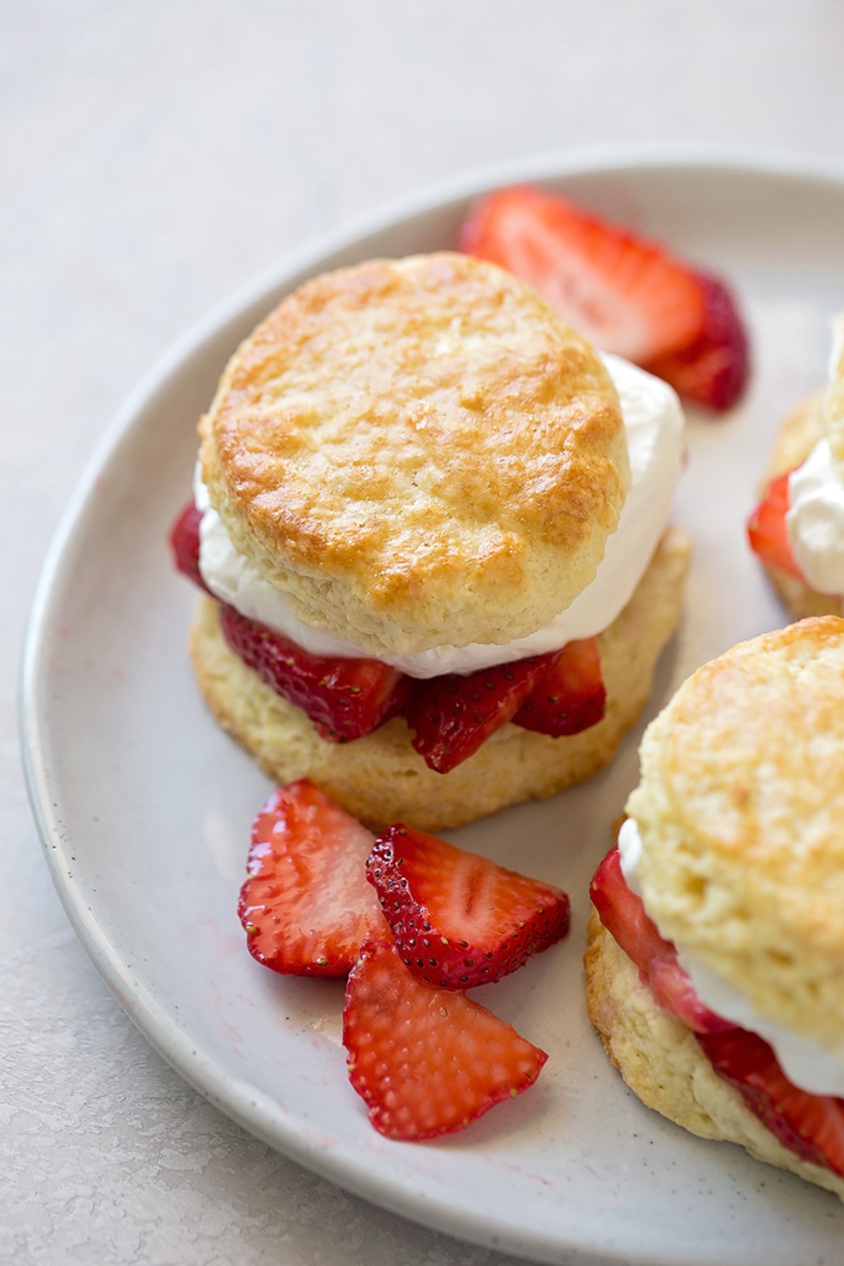 Classic Strawberry Shortcake with whipped cream on a white plate.