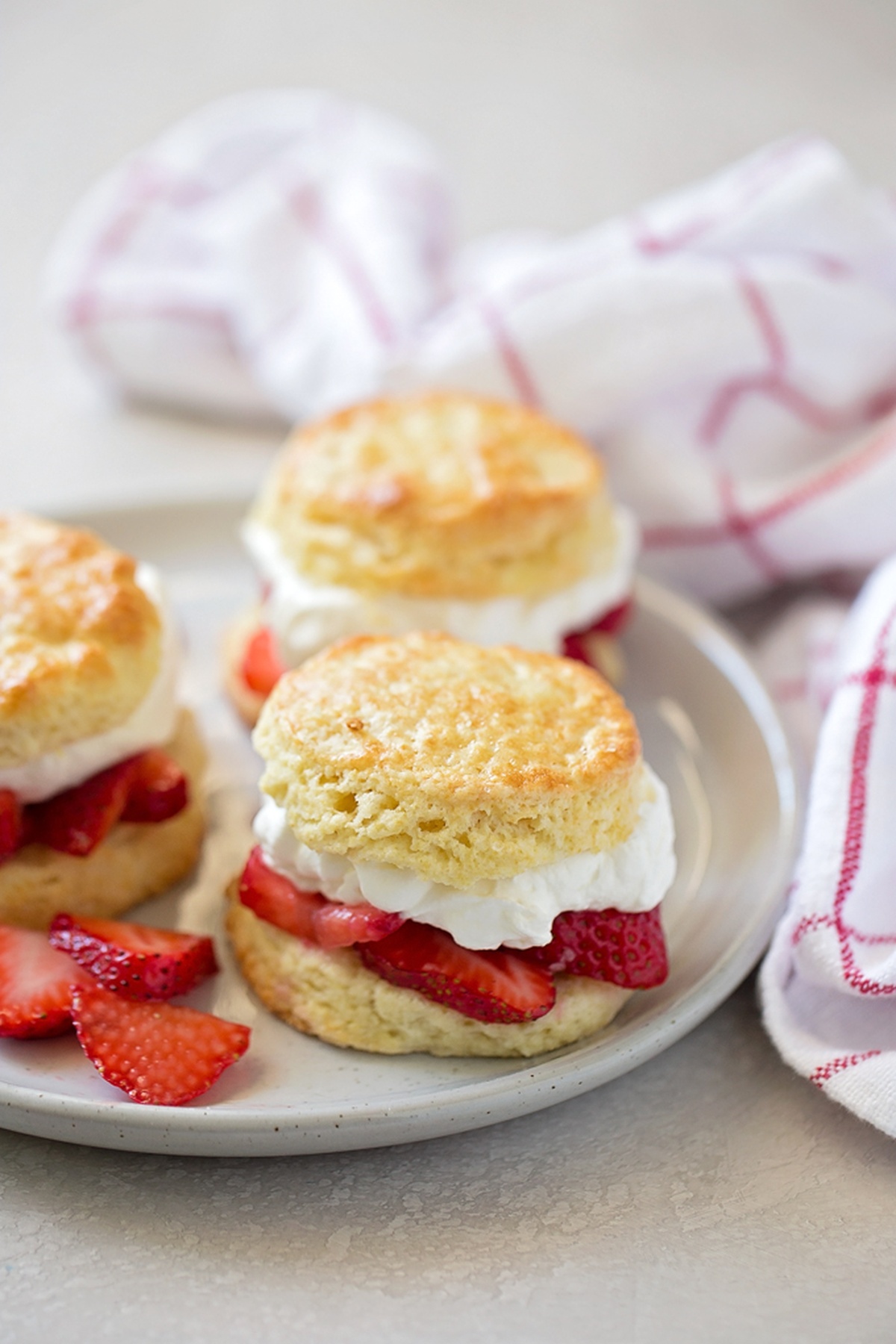 Close-up of a strawberry shortcake dessert on a plate.