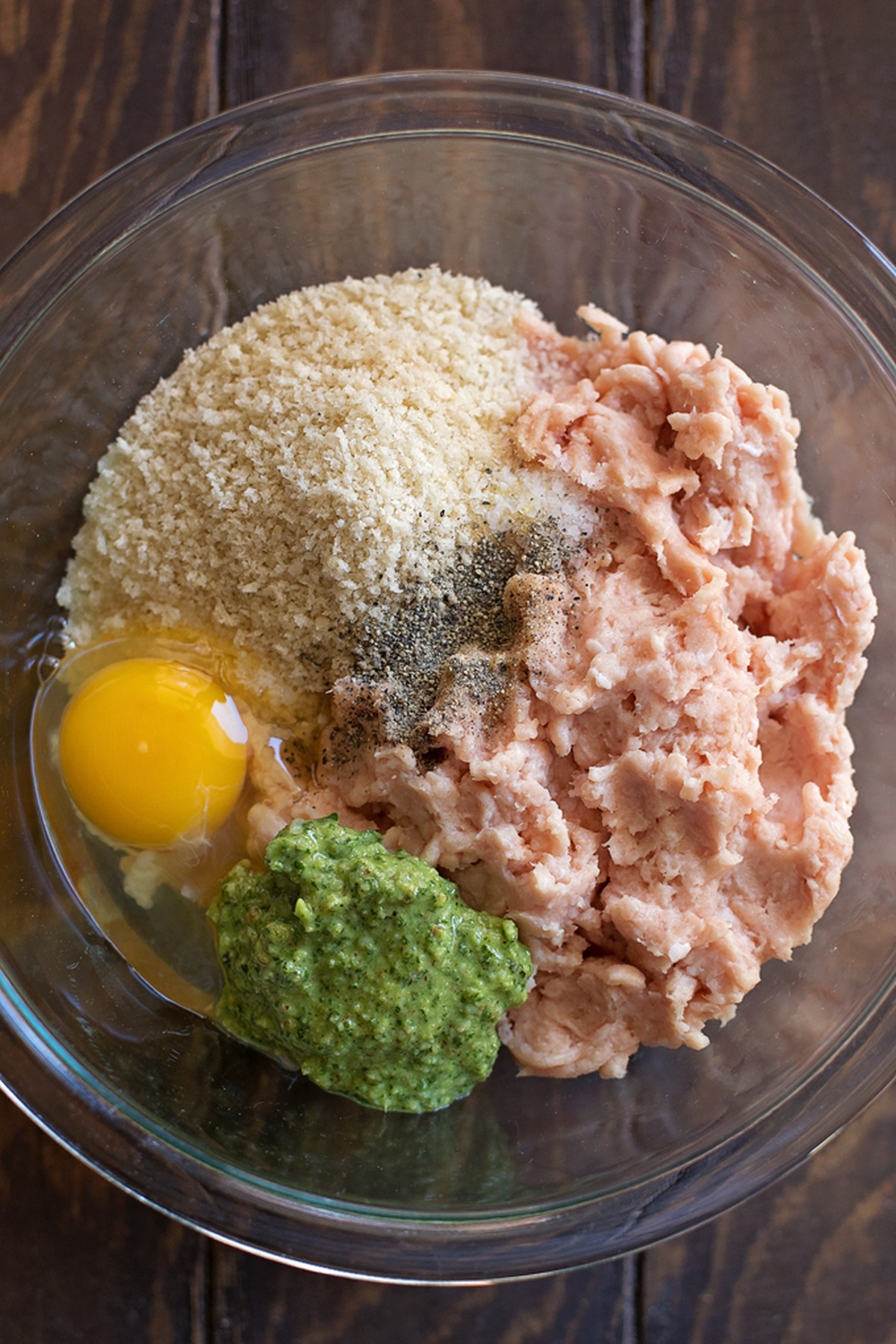 Ingredients for chicken meatballs with pesto in a food processor.
