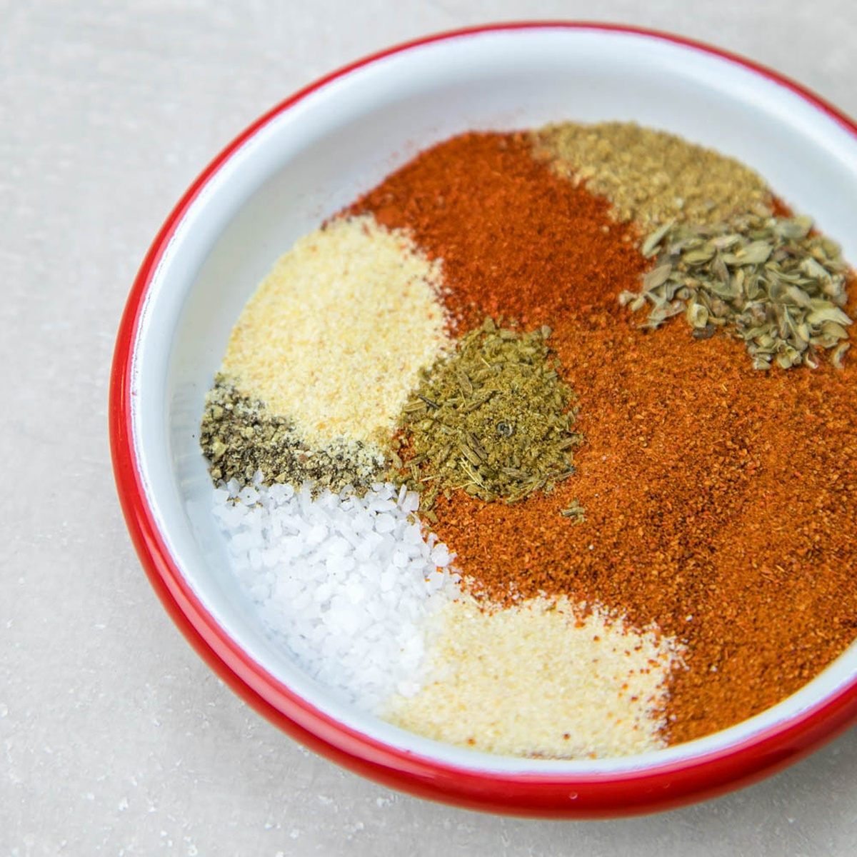 A bowl of taco seasoning ingredients arranged in separate piles.