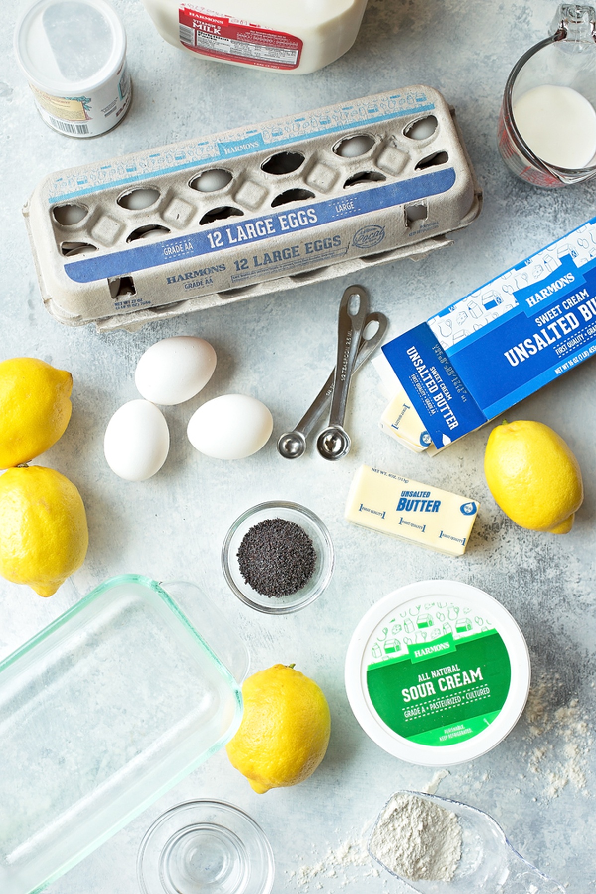 Ingredients for lemon poppy seed bread, arranged on a light background.