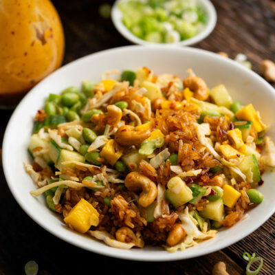 Dive into this Crispy Rice Salad Recipe. Packed with cucumber, mangoes, edamame, cashews, and crispy rice, you will love this flavor and texture packed salad.