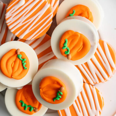 These Pumpkin Cake Pops are bite-sized treats made with moist spiced pumpkin cake, coated in sweet candy melts, and decorated for Fall!
