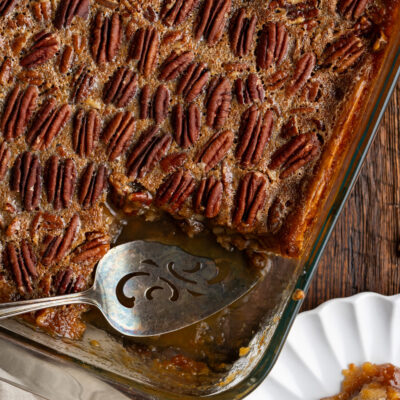Indulge in this Pecan Pie Cobbler recipe. Gooey caramelized pecan goodness served as a warm spoonable dessert that everyone will love!