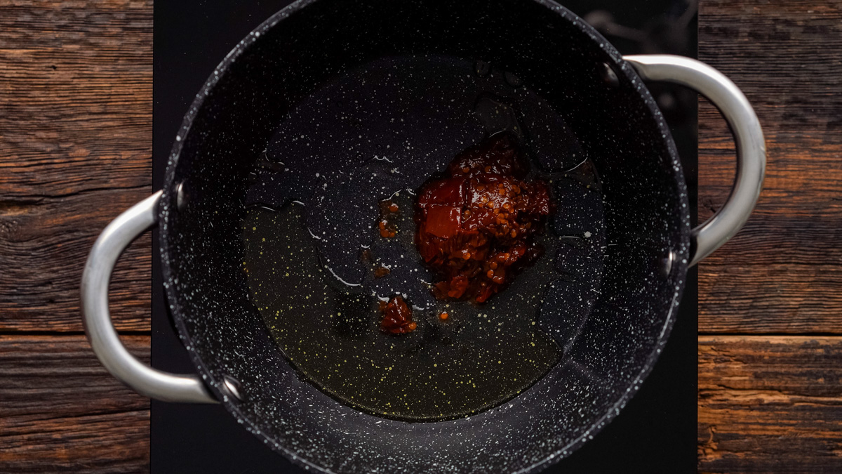 Chipotle peppers and oil in a saucepan.