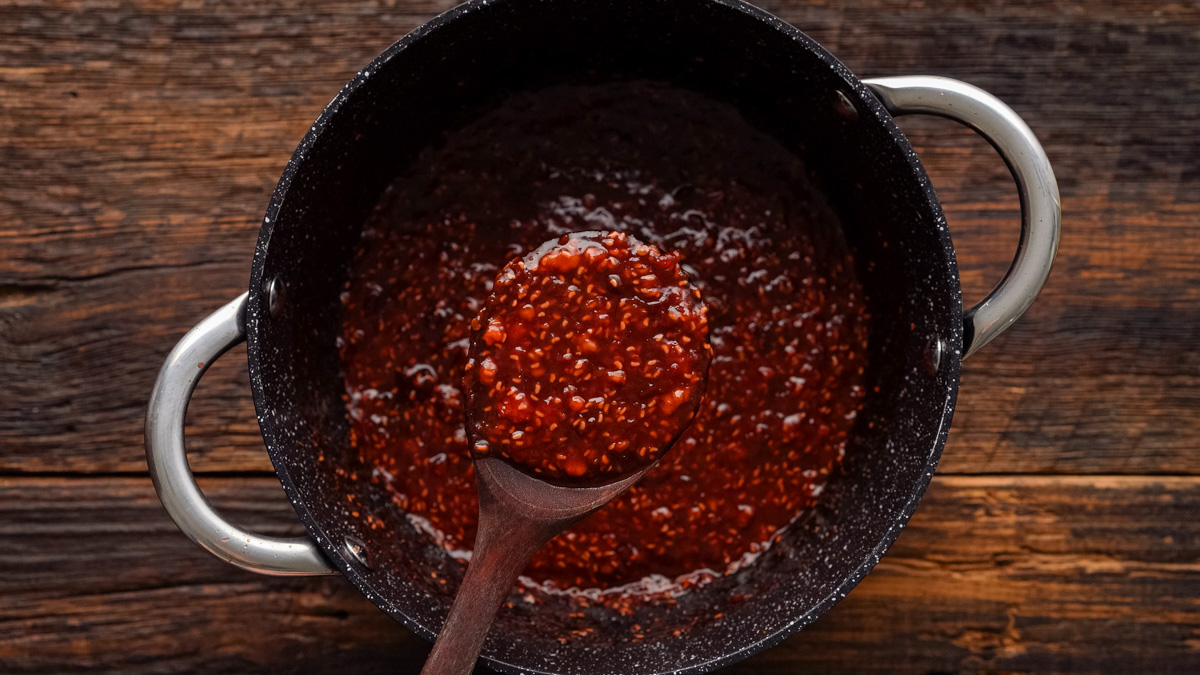 Chipotle raspberry sauce in a saucepan.