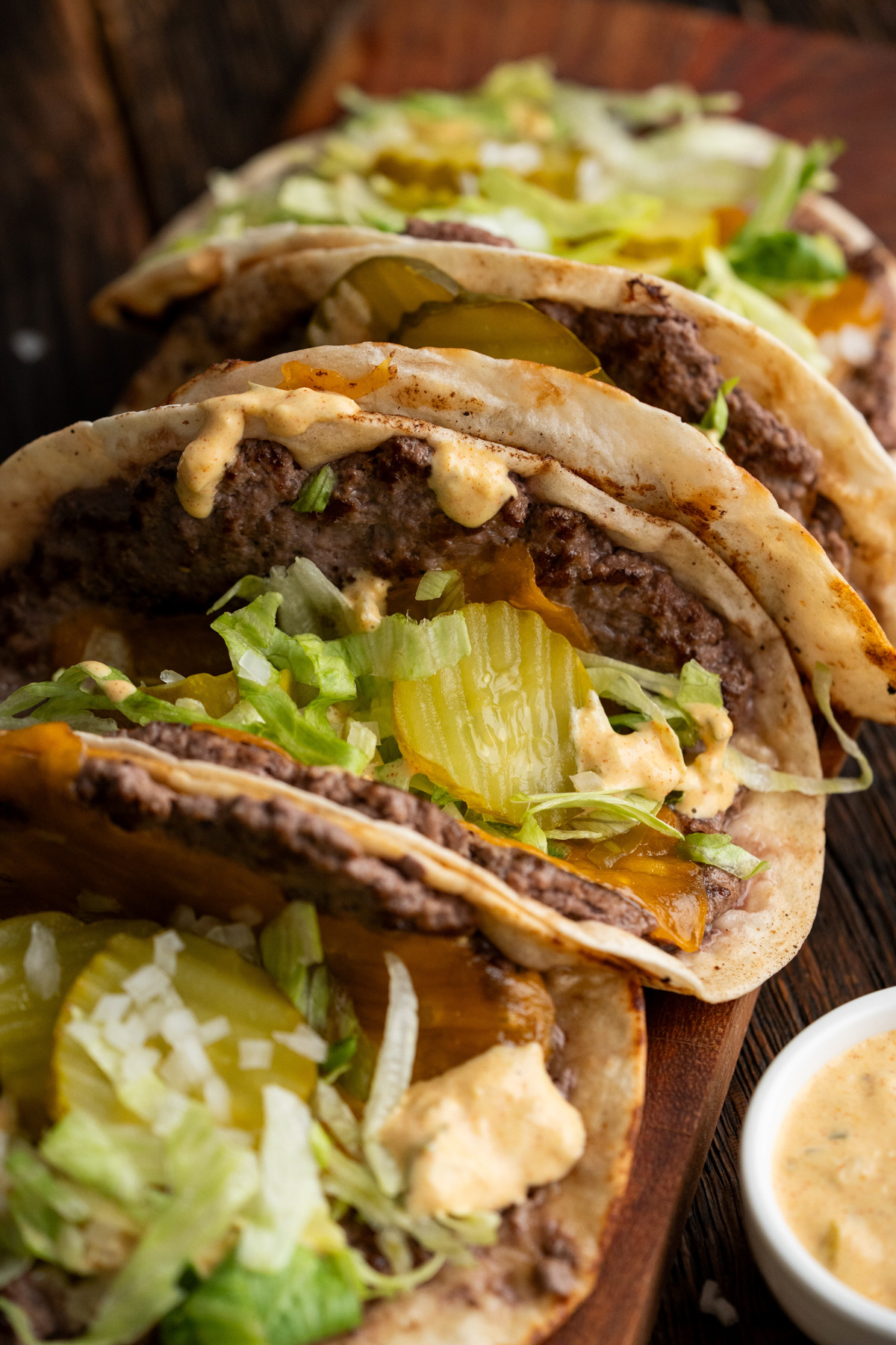 Big mac tacos on a cutting board.