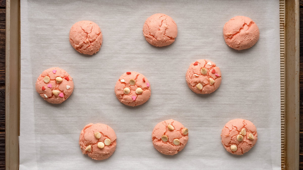 Cookie dough balls on a baking sheet after baking.