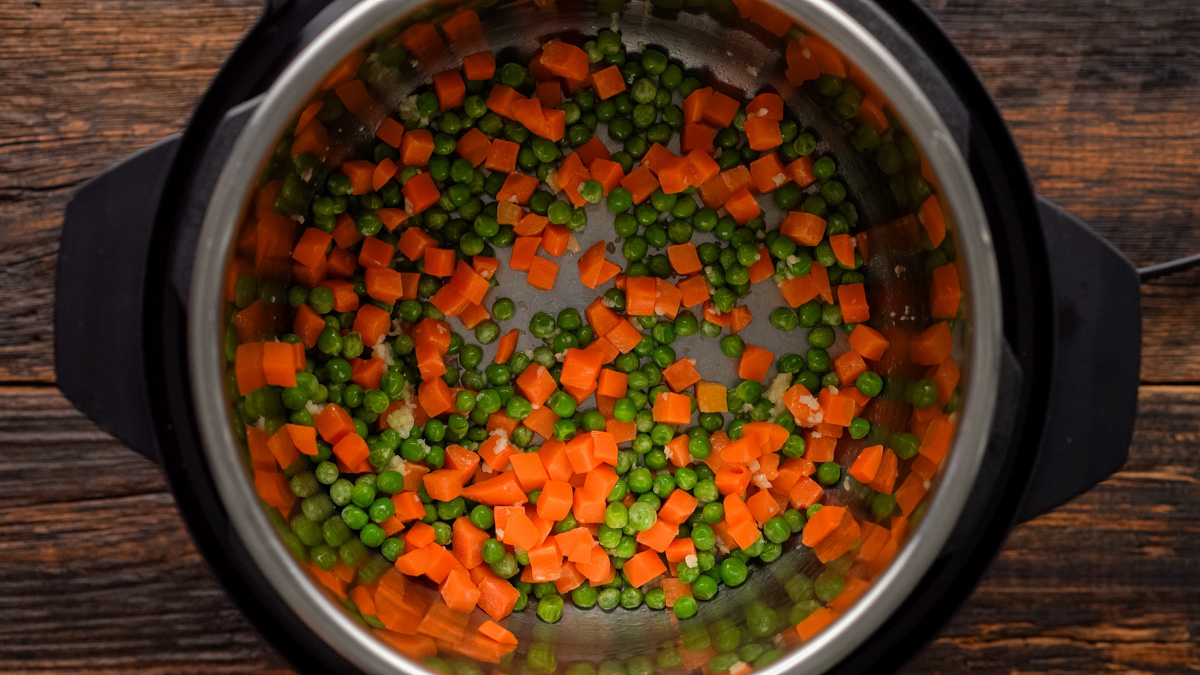 Peas and carrots added to the instant pot.