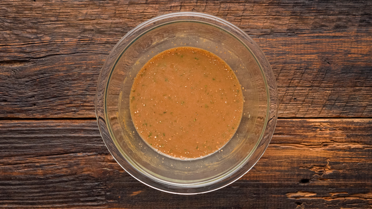 Liquid mixture for meatballs in a glass bowl.