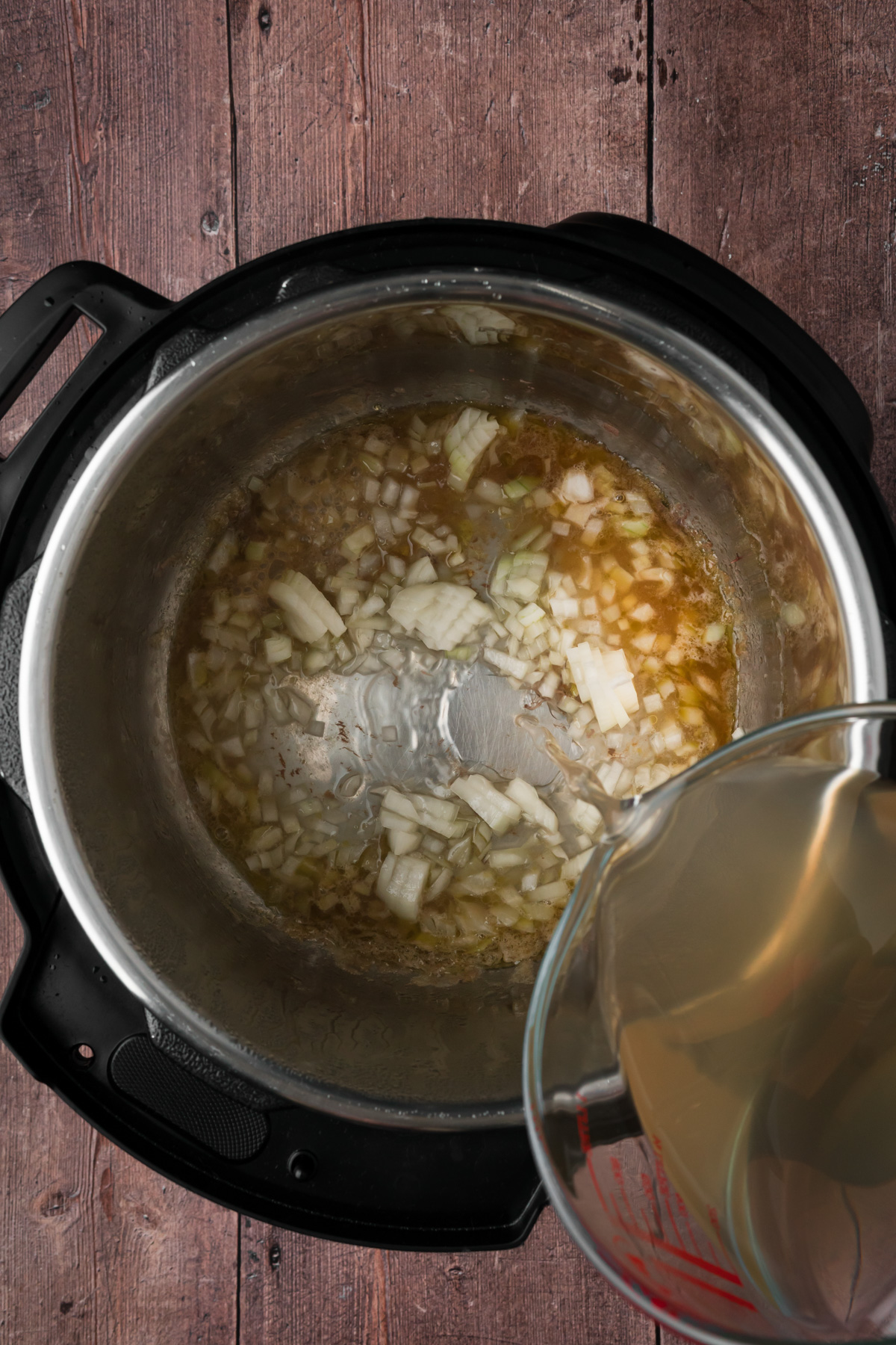 Broth and onions added into the Instant pot.