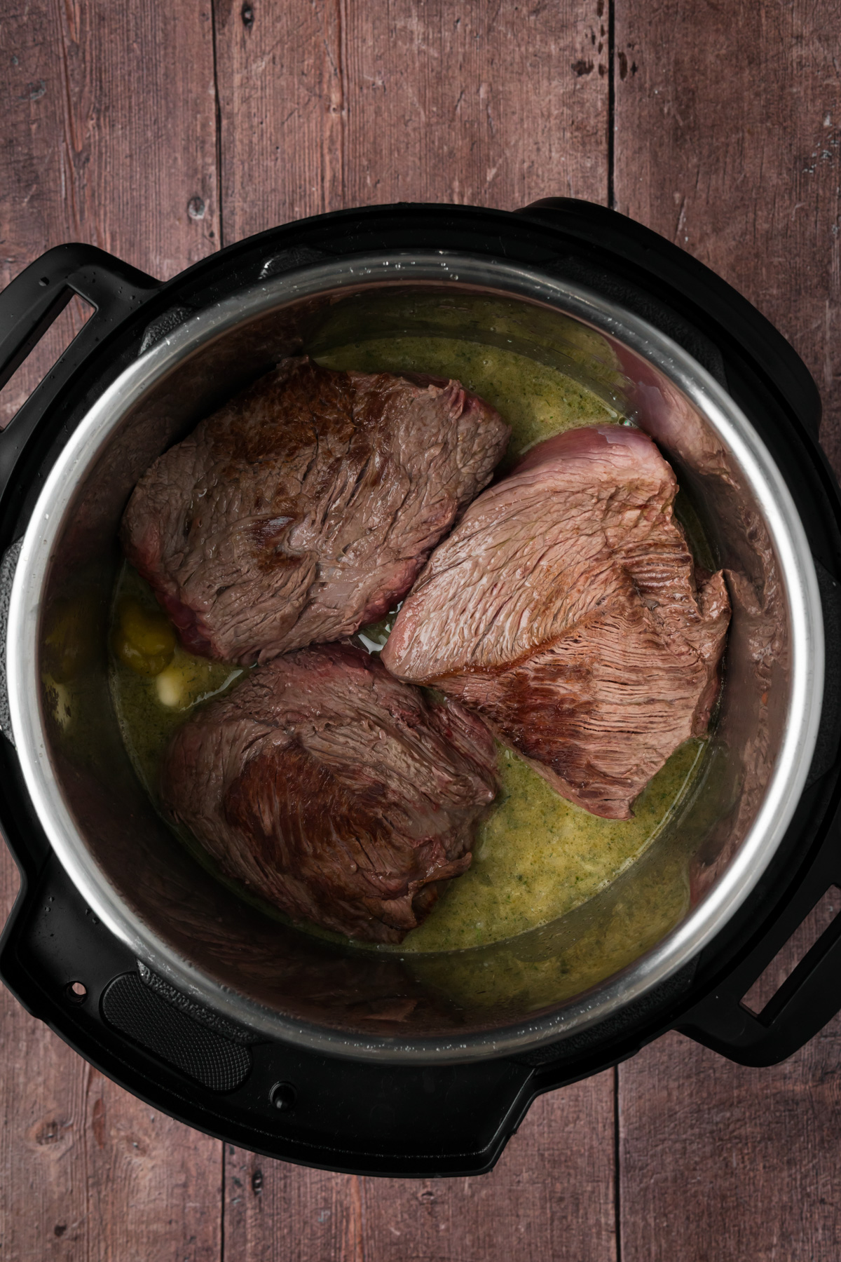 Chuck roast added back into the Instant Pot.